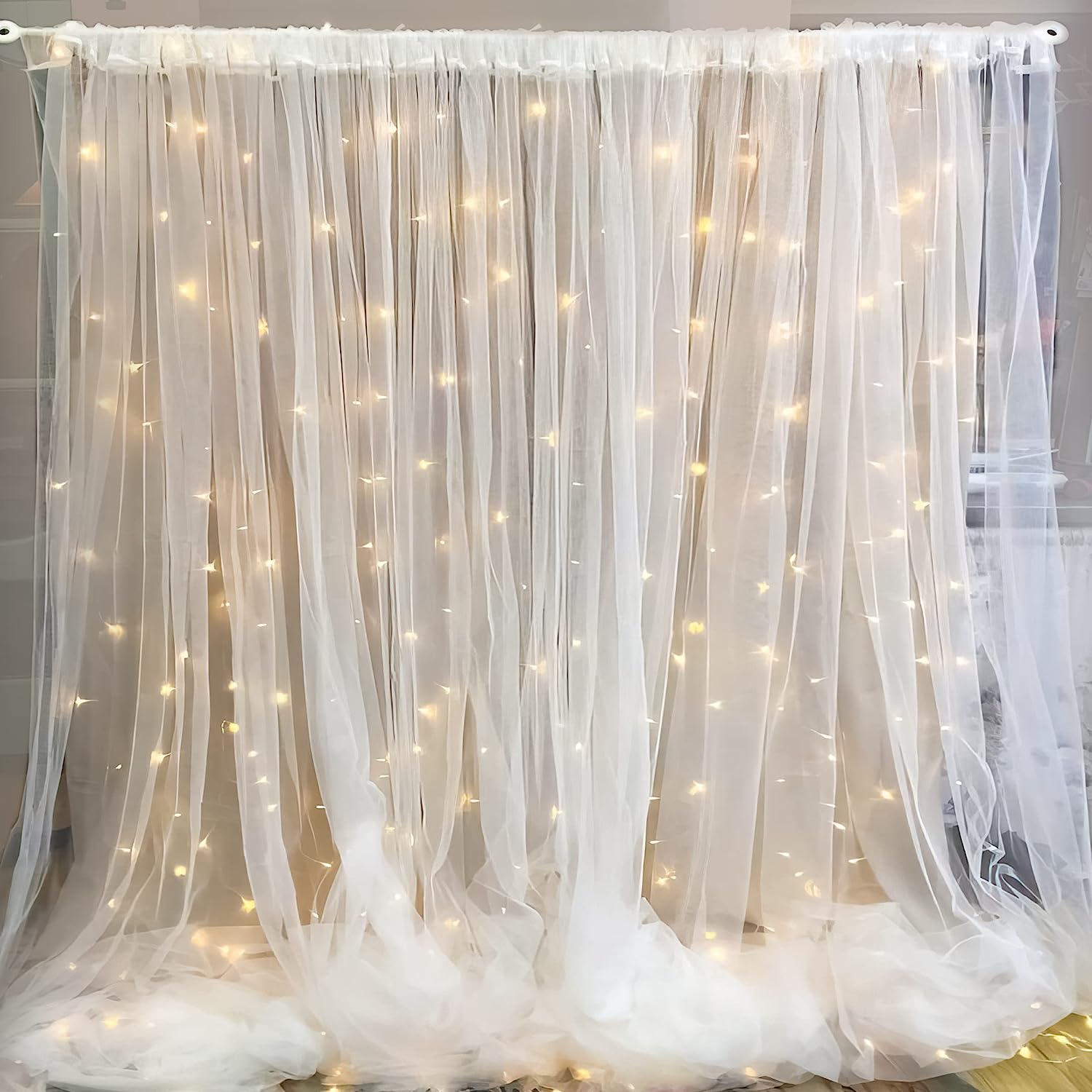 Tulle white sheer net with LED string lights for a party backdrop